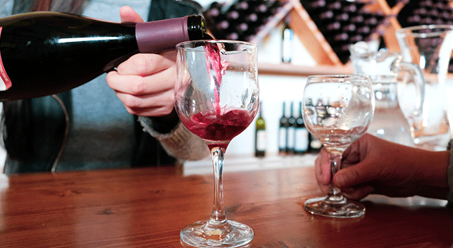 wine being poured from a wine bottle into a wine glass